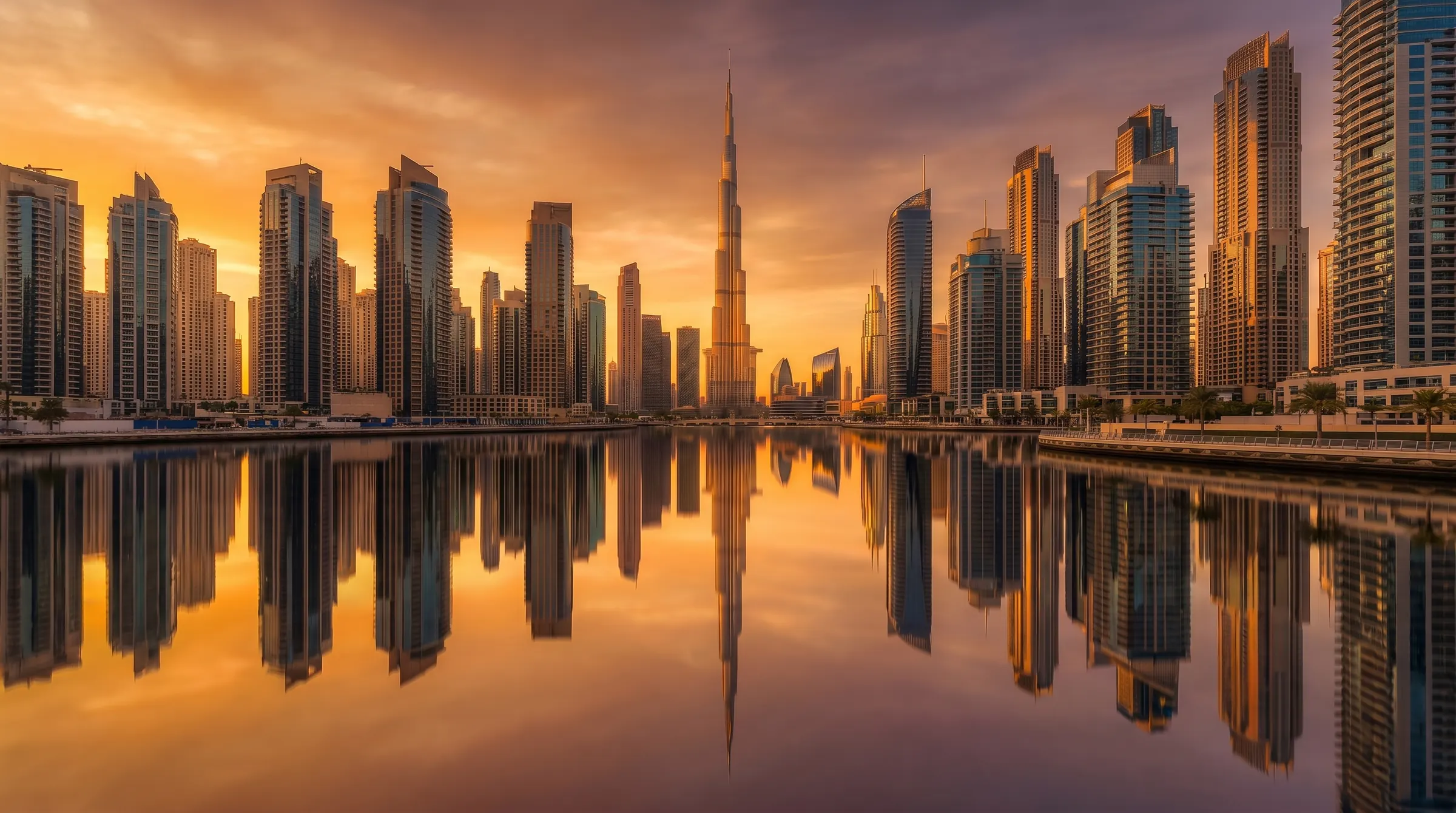 The Dubai skyline reflected in water at golden hour